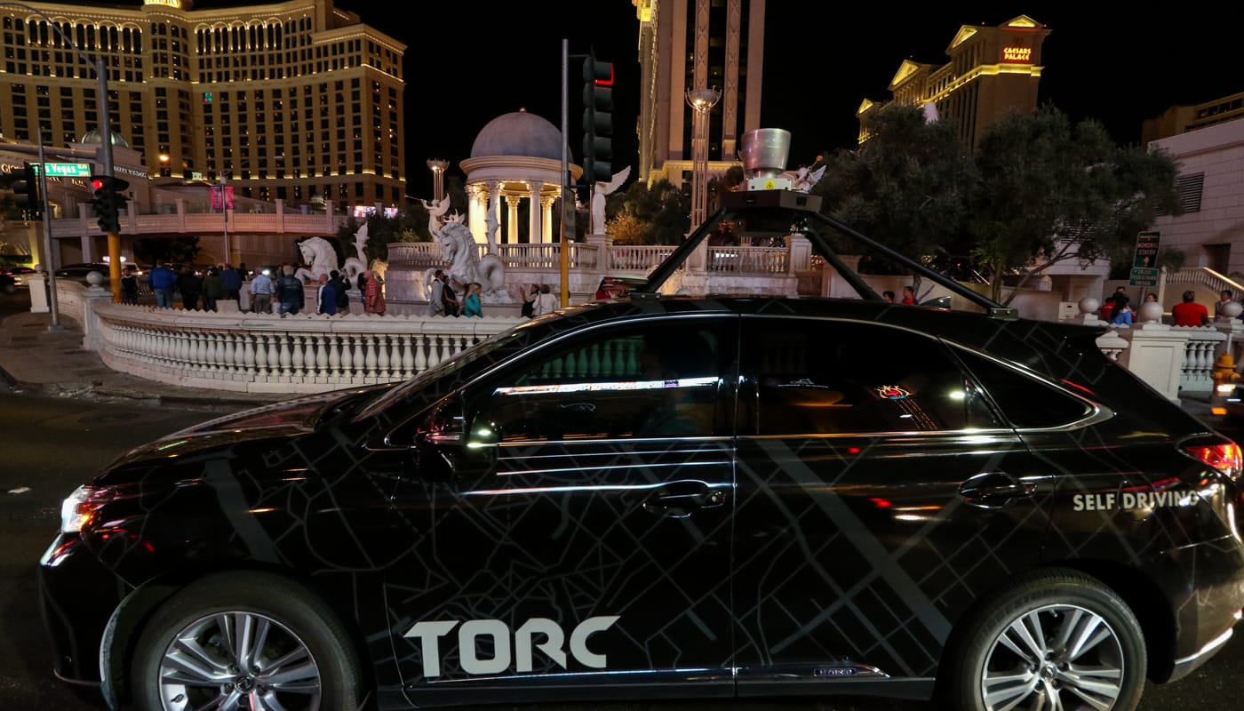 Torc vehicle driving through Las Vegas at night.