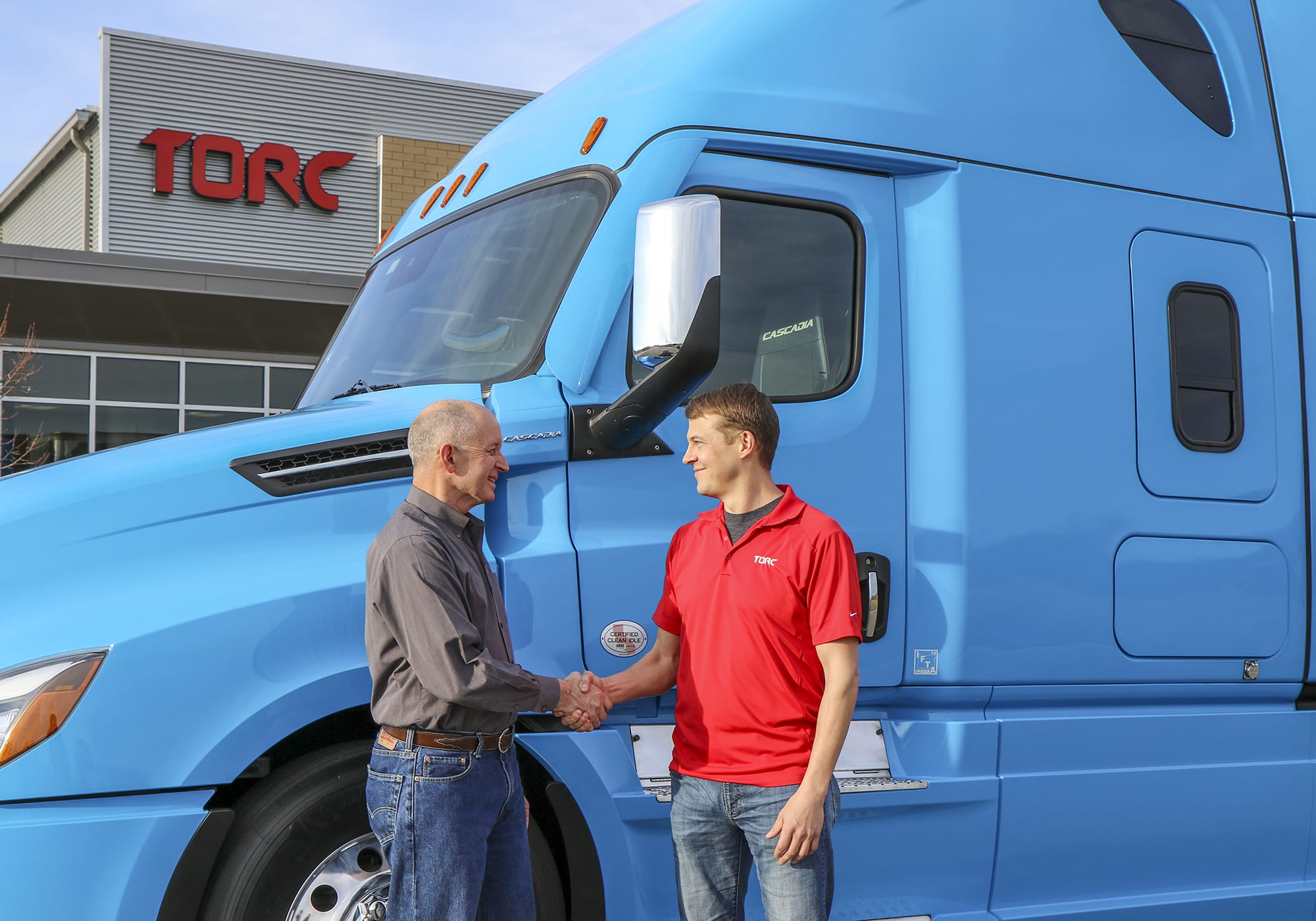 Roger Nielsen, CEO of Daimler Trucks North America LLC, (left) and Michael Fleming, CEO of Torc Robotics, celebrate the new partnership between their two companies.