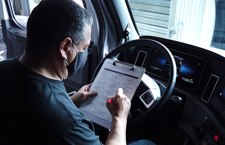 torc employee looking over testing notes in a vehicle