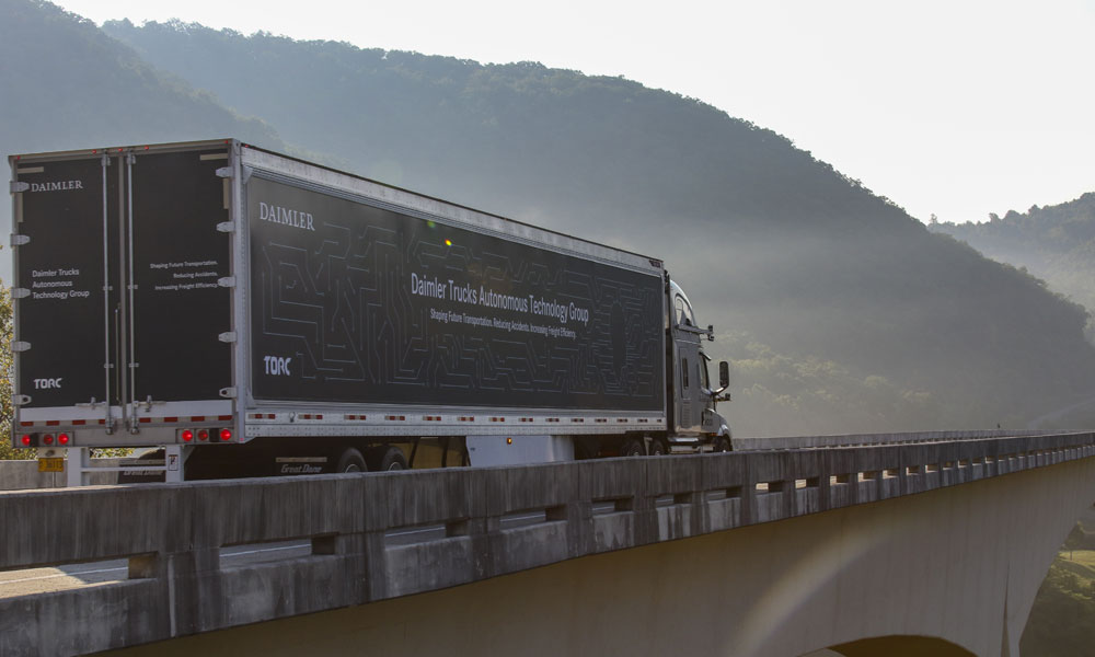 An autonomous truck driving over a bridge.