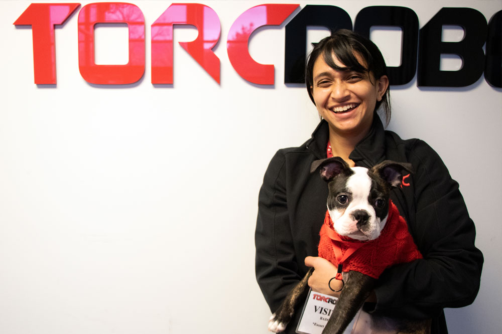 Torc team member holding a dog.