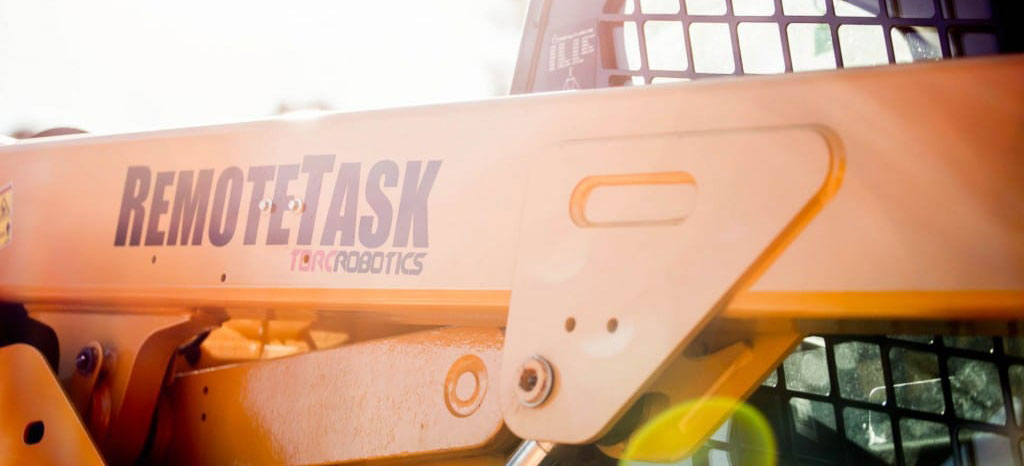 Torc Remote task logo on the side of a construction vehicle.