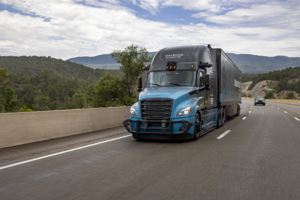 A Torc branded Daimler truck cruising on the highway.