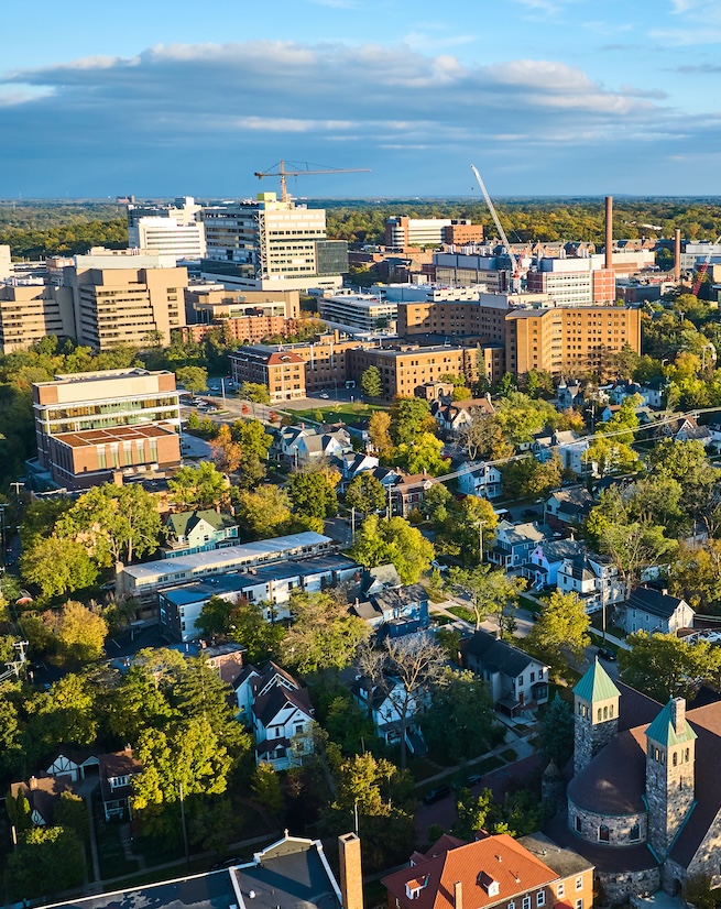 Aerial Golden Hour Over Historic Church and Urban Growth, Ann Arbor