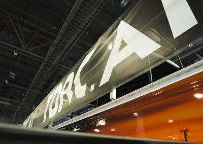 A banner that reads, "Torc.AI" on a convention center floor.