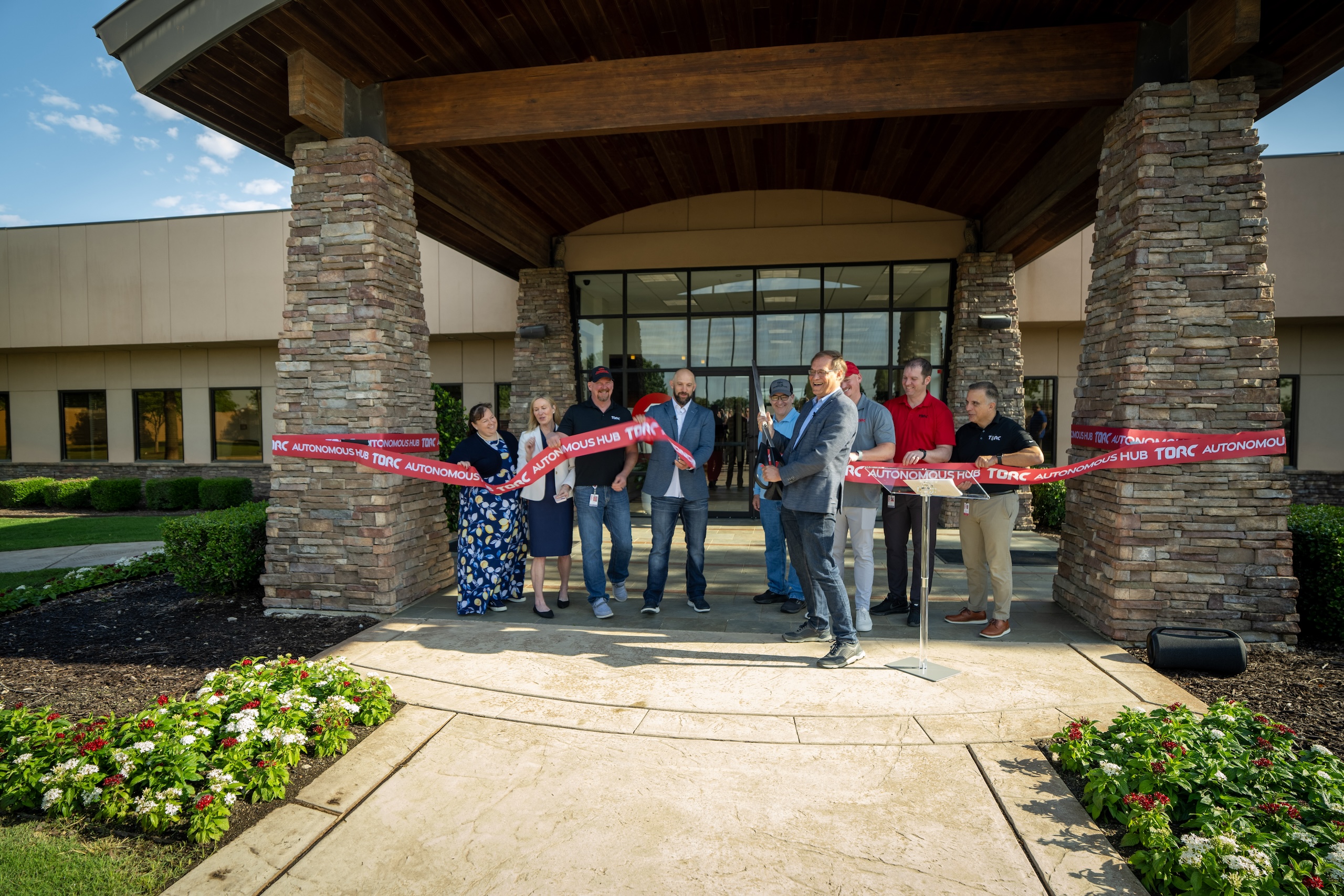 ribbon-cutting-torc Torc CEO Peter Vaughn Schmidt cuts the ribbon at the official opening of the new autonomous trucking hub.